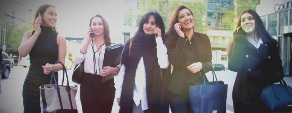 Female Lawyers with phones walking for video shoot