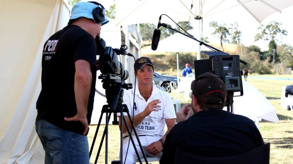 Photo of Director and Cameraman interviewing a polo player