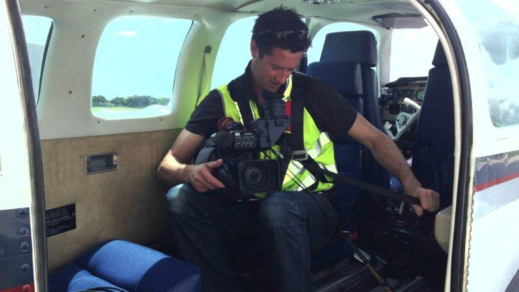 Camera Operator in plane with camera