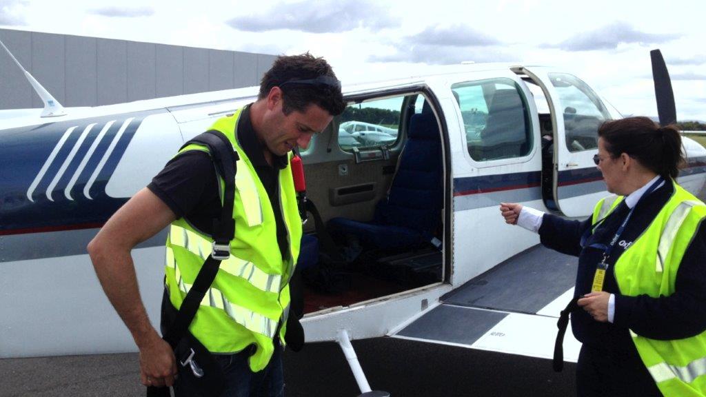 Camera Operator getting ready to film from light plane