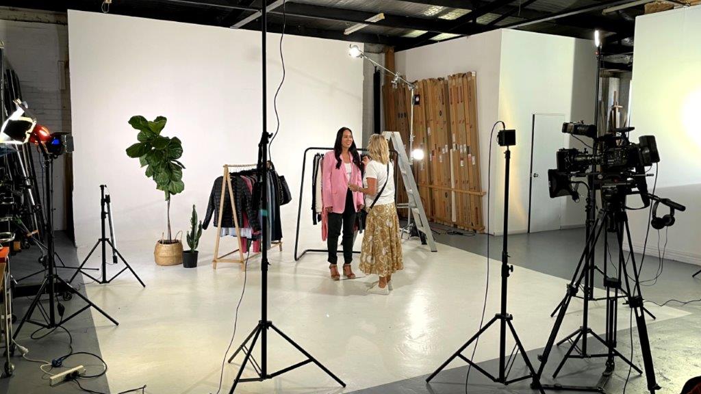 wide photo of studio with presenter and makeup artist